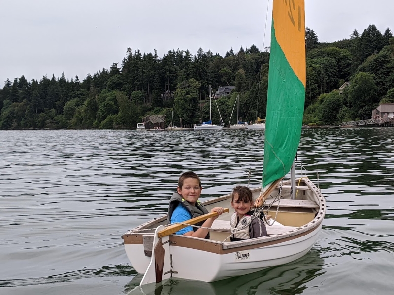 Cruiser kids sailing a 10-foot Ranger sailing dinghy at Dockton at Vashon Island in the south sound