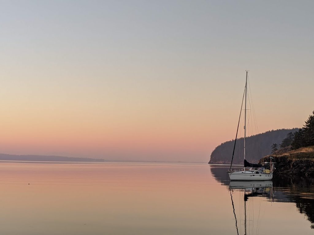 The sailboat SV Muse sitting at anchor in the gorgeous sunset light just north of Saddle Bag Island