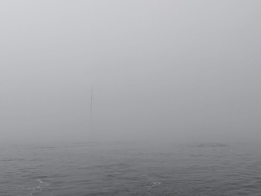 Muse's mast barely in view from our stern, in the thick fog of the San Juans