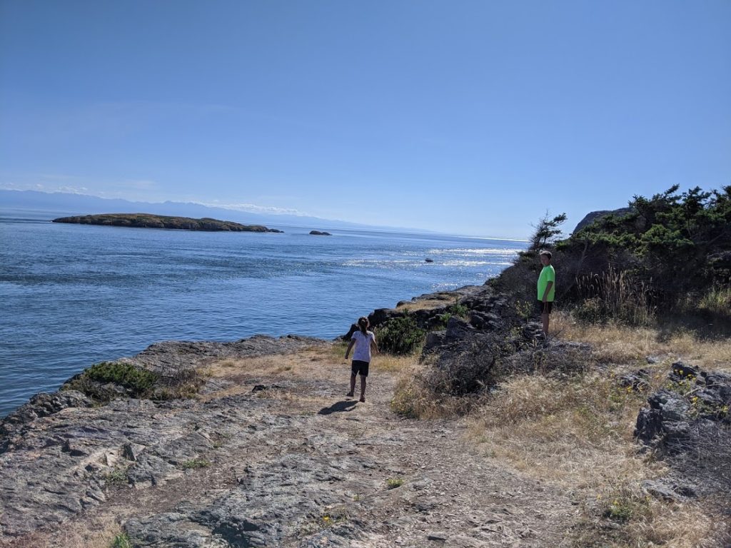 The kids taking in the views along the train at Point Colville on Lopez Island in the San Juans - cruiser's review anchorage review