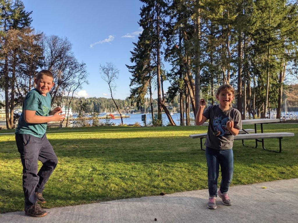 Pinecone wars with kids in the park at the Eagle Harbor waterfront