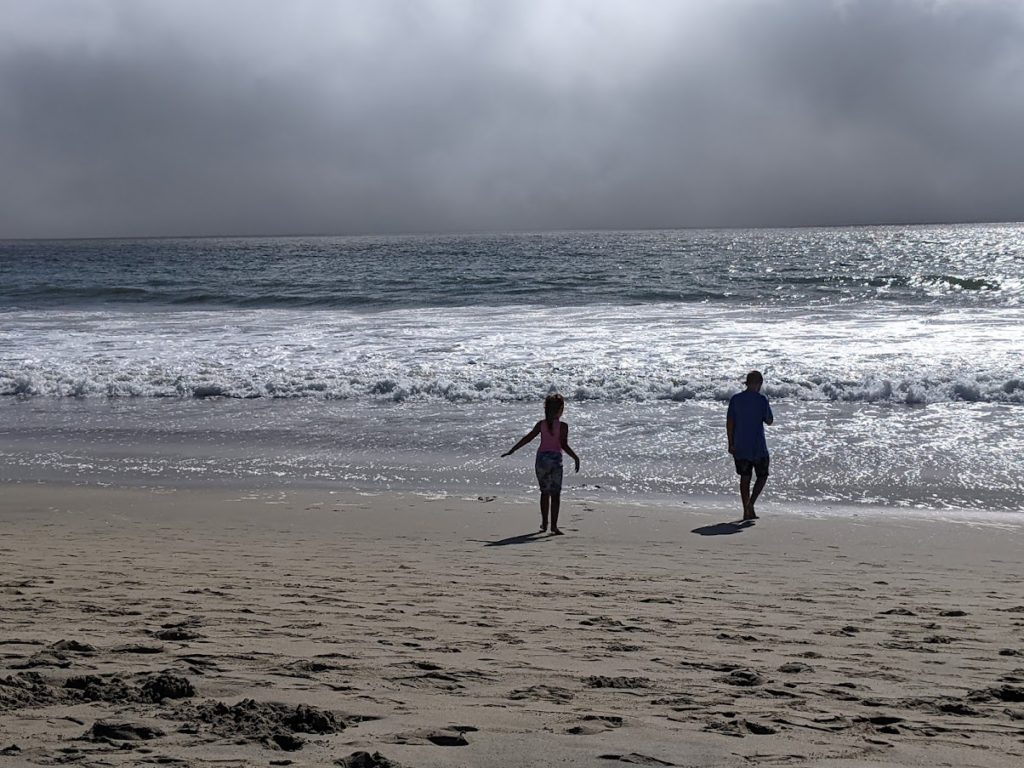 Our kids playing in the surf on the beach at Half Moon Bay