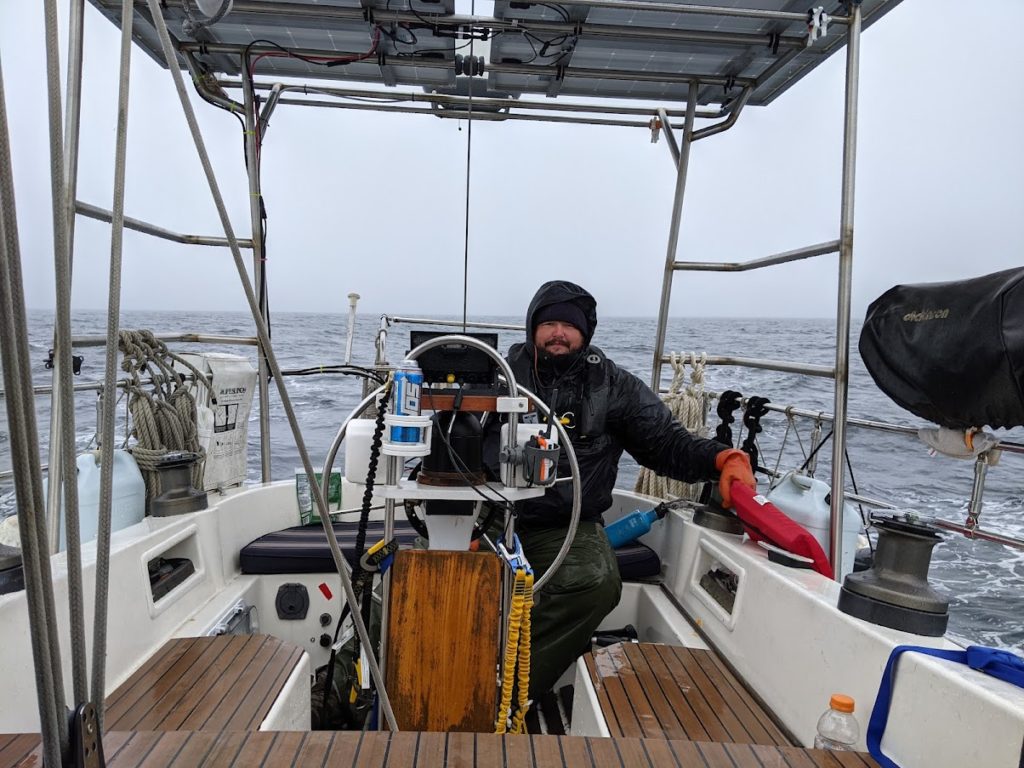 Brenden on watch in the cockpit as we round cape mendocino in wind and rain during our southbound passage on the west coast