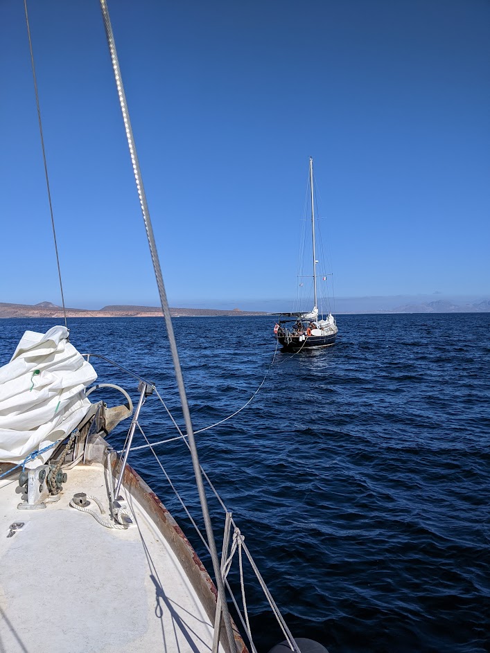 Cruising Meraki towing Mosaic Voyage back to safe anchorage near La Paz, BCS, Mexico